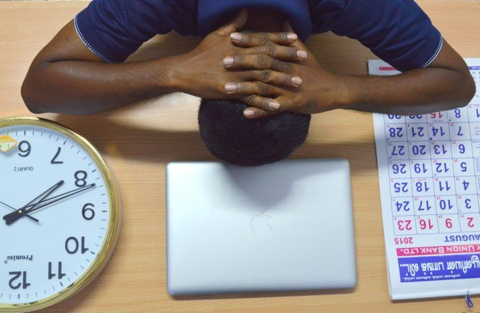 Man with head on table in distress